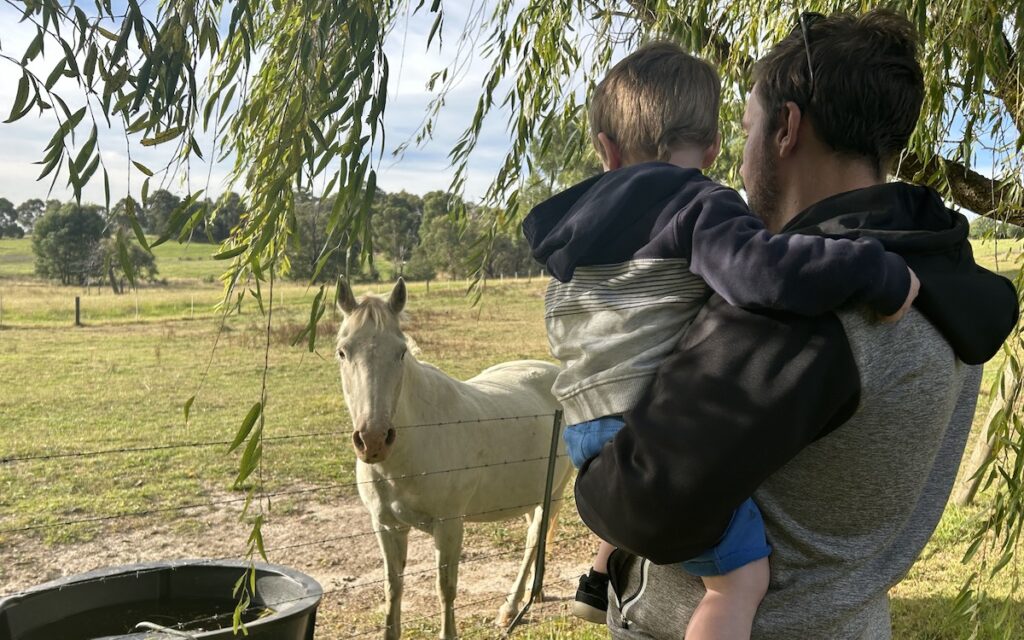 Young boy and dad at Wiggly Bottom Farm at a farm stay in Victoria